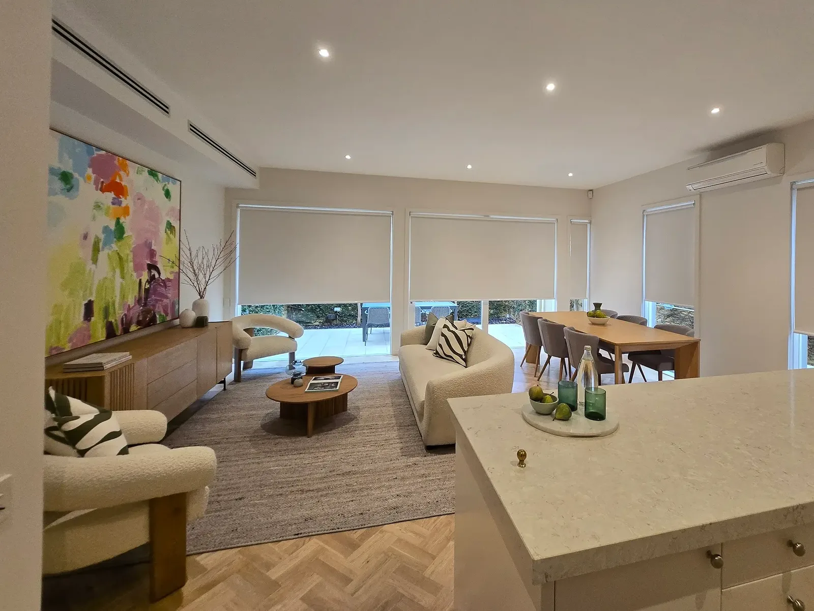 Open-plan living and dining room with roller blinds