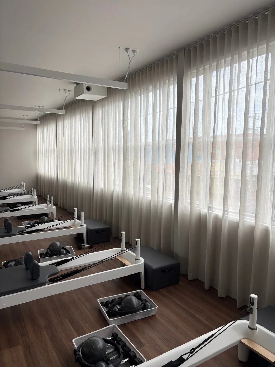Floor-to-ceiling sheer curtains installed across a Melbourne studio by Tailored Blinds